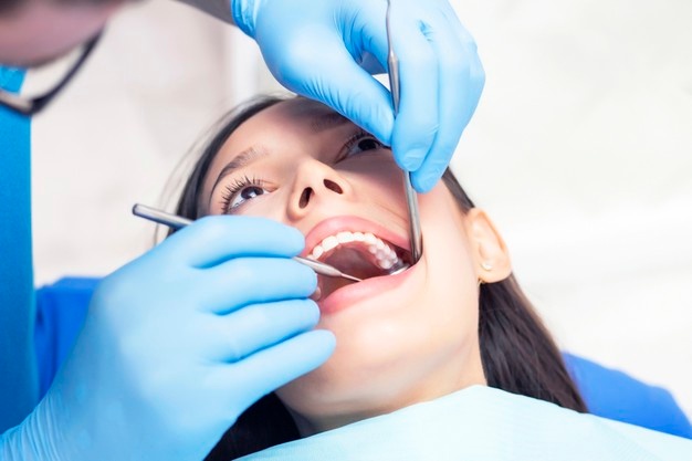 young-woman-checks-her-teeth_170532-1856