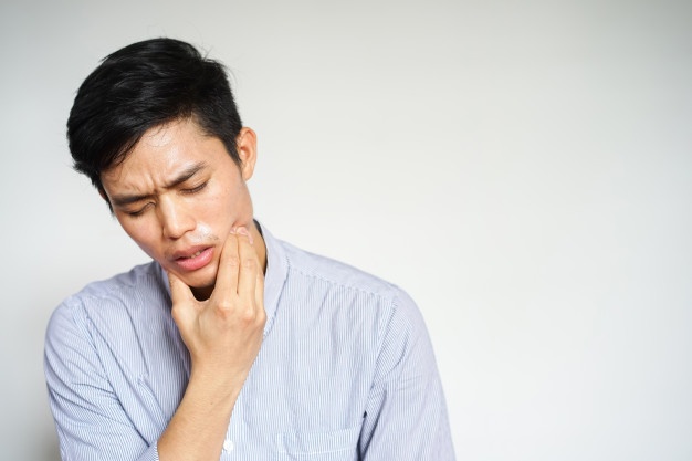 close-up-asian-man-feeling-pain-from-toothache_42708-605